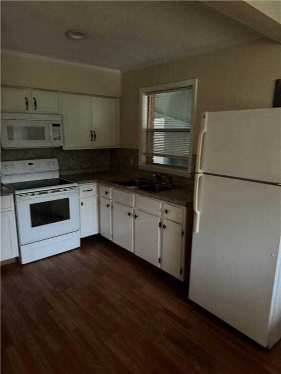 kitchen featuring decorative backsplash, white appliances, white cabinetry, and dark wood-type flooring