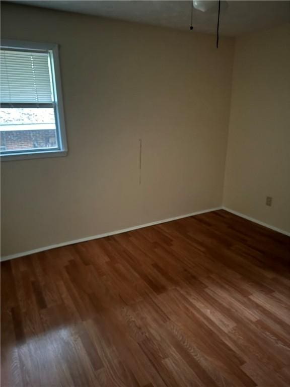 spare room featuring dark hardwood / wood-style flooring