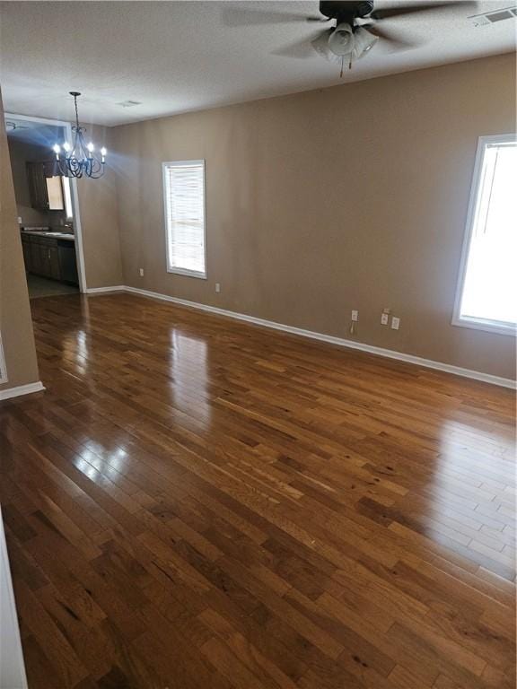 714 Ellis St N, Auburn, AL 36832 - empty room with a chandelier, dark wood finished floors, and ceiling fan
