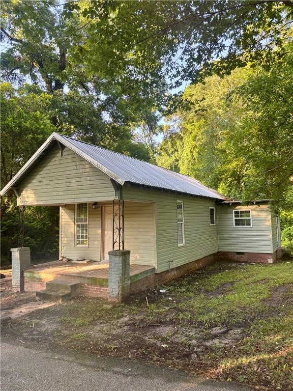 204 S 1st Pl, Opelika, AL 36801 - view of front of home with a porch, a metal roof, and crawl space