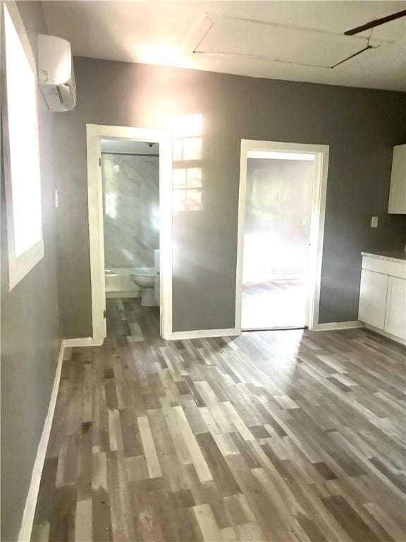204 S 1st Pl, Opelika, AL 36801 - unfurnished dining area with an AC wall unit, wood finished floors, and attic access