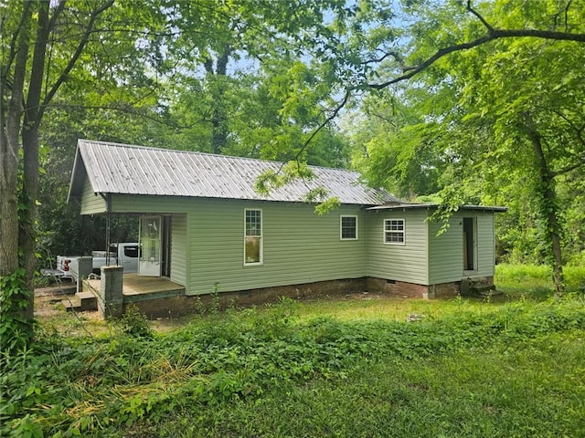 204 S 1st Pl, Opelika, AL 36801 - rear view of property featuring crawl space and a metal roof