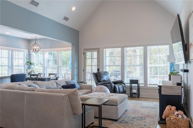 living room featuring lofted ceiling and a chandelier