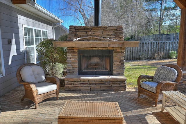 view of patio with an outdoor stone fireplace