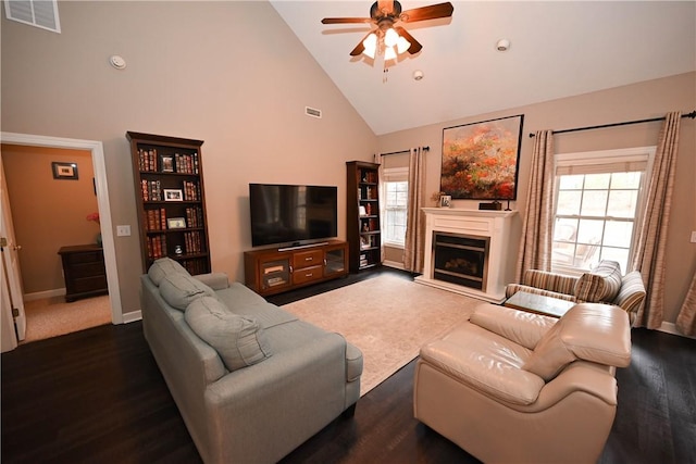 living room featuring ceiling fan, dark hardwood / wood-style floors, and high vaulted ceiling