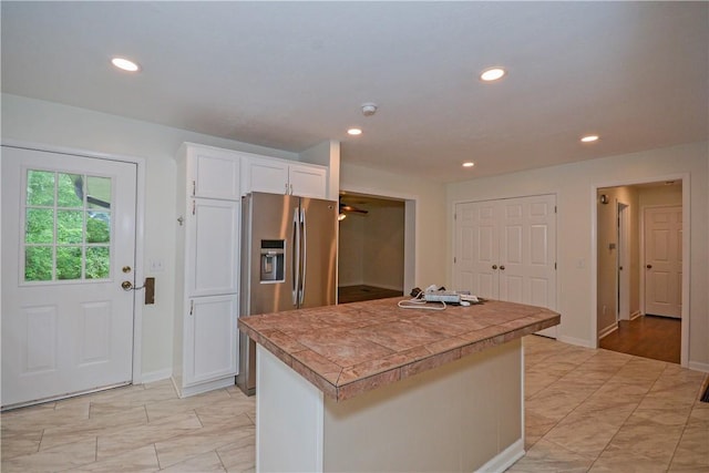 222 Green St, Auburn, AL 36830 - kitchen with stainless steel refrigerator with ice dispenser, white cabinetry, baseboards, a center island, and recessed lighting
