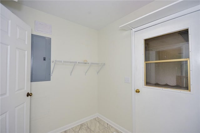 222 Green St, Auburn, AL 36830 - laundry room featuring electric panel, baseboards, and light marble finish floors