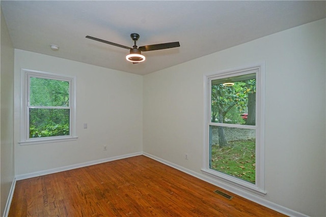 222 Green St, Auburn, AL 36830 - spare room featuring healthy amount of natural light, a ceiling fan, baseboards, and wood finished floors
