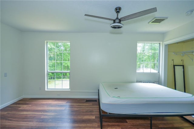 222 Green St, Auburn, AL 36830 - bedroom with dark wood-type flooring, multiple windows, and baseboards