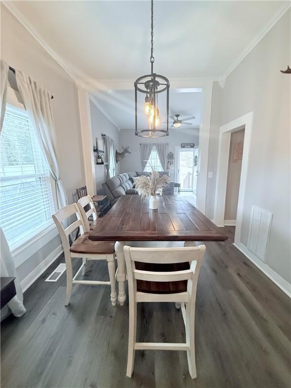 unfurnished dining area with crown molding, wood finished floors, and visible vents