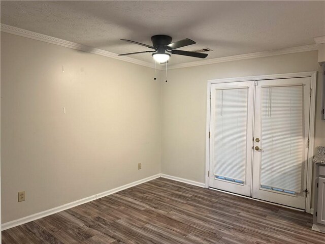 spare room featuring ornamental molding, ceiling fan, dark wood-style flooring, baseboards, and french doors