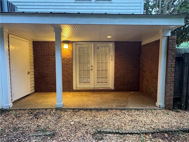 entrance to property featuring brick siding