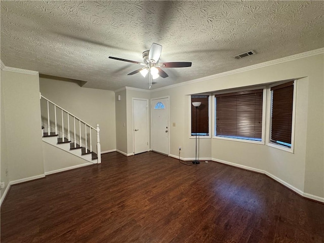 foyer entrance featuring stairway, visible vents, baseboards, wood finished floors, and a ceiling fan