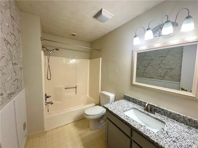 bathroom featuring vanity, shower / bath combination, toilet, visible vents, and a textured ceiling