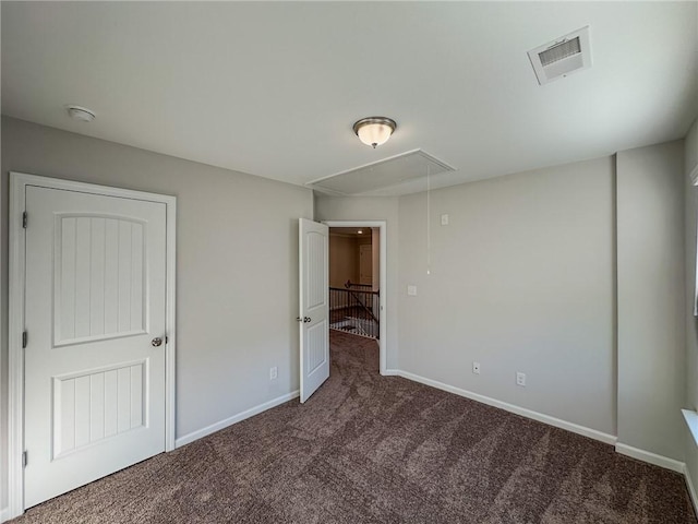 unfurnished bedroom featuring dark colored carpet