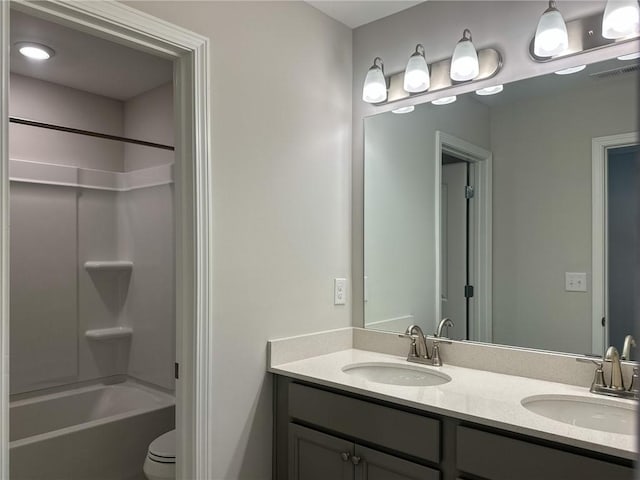 full bathroom with toilet, vanity, and bathtub / shower combination