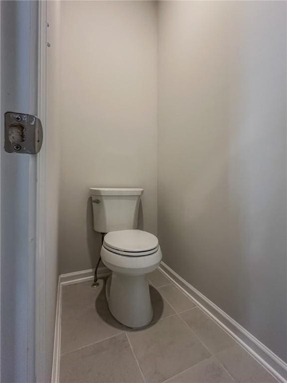 bathroom with toilet and tile patterned flooring