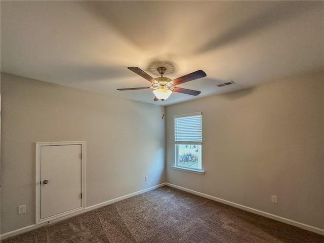 carpeted spare room with ceiling fan