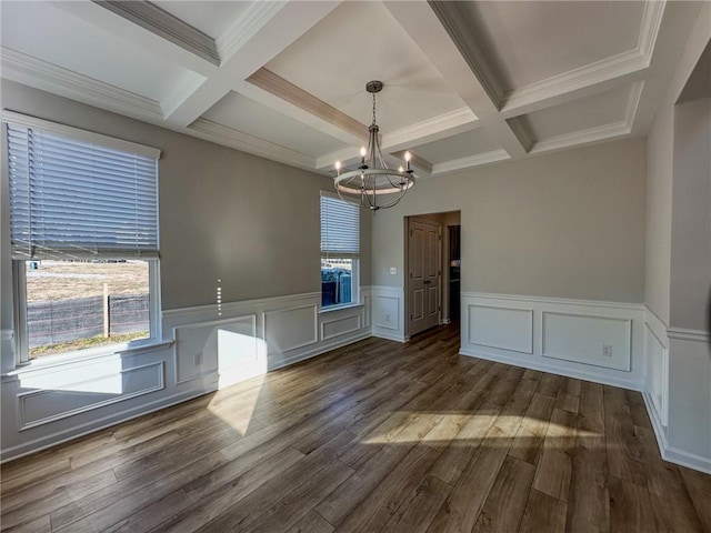 unfurnished dining area featuring a notable chandelier, beamed ceiling, and coffered ceiling