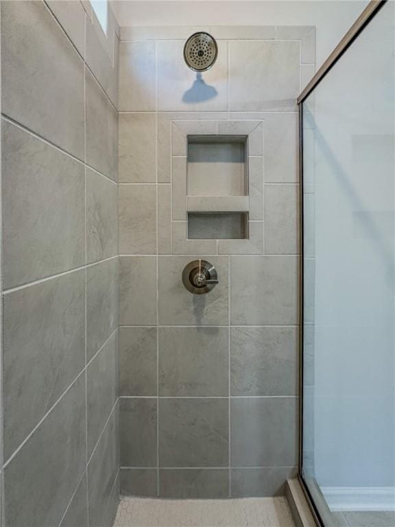 bathroom with tiled shower