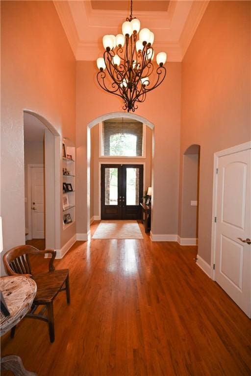 1618 Olivia Way, Auburn, AL 36830 - entrance foyer with arched walkways, a towering ceiling, a chandelier, crown molding, and french doors