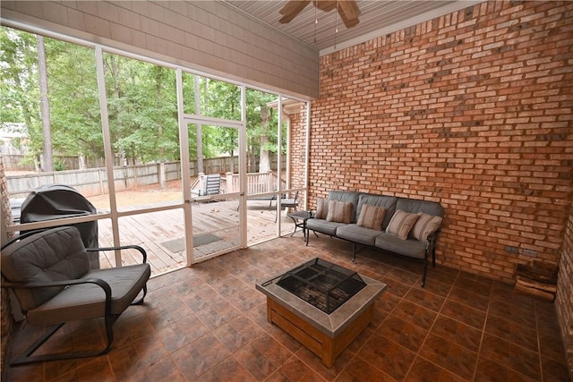 sunroom / solarium featuring ceiling fan