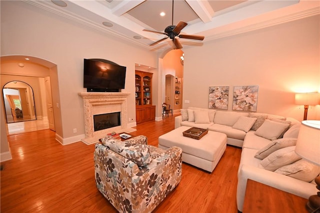 1618 Olivia Way, Auburn, AL 36830 - living area with arched walkways, coffered ceiling, a high end fireplace, wood finished floors, and beamed ceiling
