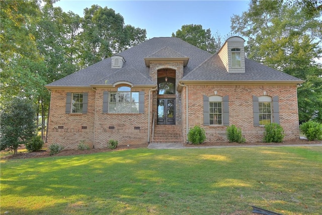 french provincial home with a front yard