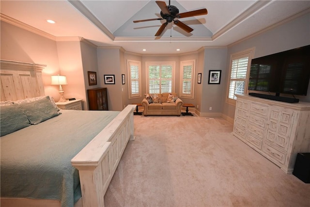 carpeted bedroom featuring multiple windows, a tray ceiling, ceiling fan, and ornamental molding