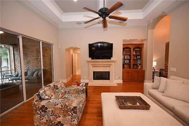 1618 Olivia Way, Auburn, AL 36830 - living room with arched walkways, a tray ceiling, ceiling fan, wood finished floors, and crown molding