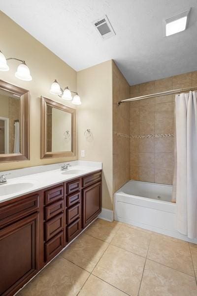 bathroom featuring tile patterned flooring, vanity, and shower / bathtub combination with curtain