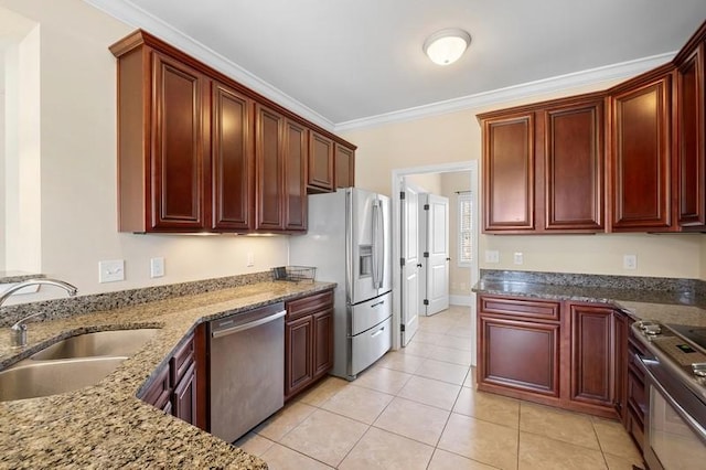 kitchen featuring crown molding, appliances with stainless steel finishes, sink, and dark stone countertops