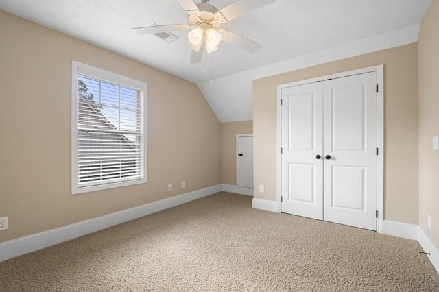 additional living space with ceiling fan, lofted ceiling, and carpet