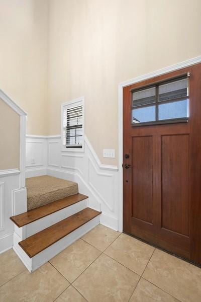 tiled entryway with a high ceiling