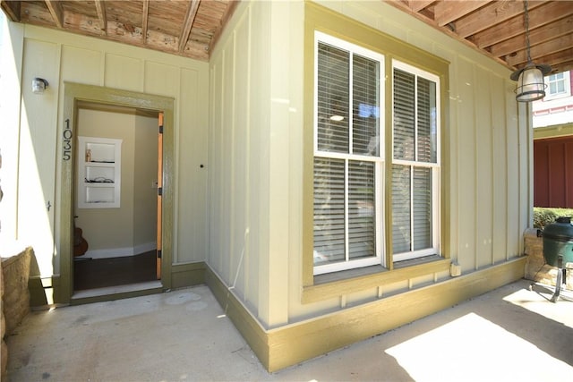 view of exterior entry featuring board and batten siding