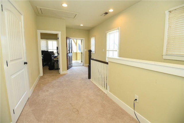 hallway with light carpet, baseboards, visible vents, and recessed lighting