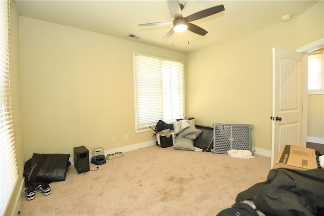 misc room with baseboards, visible vents, carpet floors, and ceiling fan