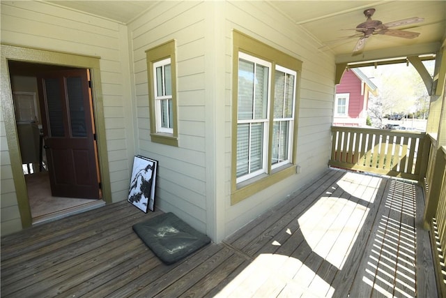wooden deck featuring a ceiling fan