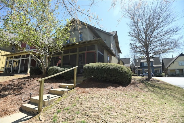 view of side of home featuring a sunroom
