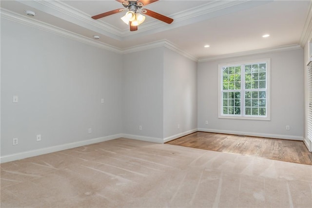 carpeted spare room featuring ceiling fan and ornamental molding