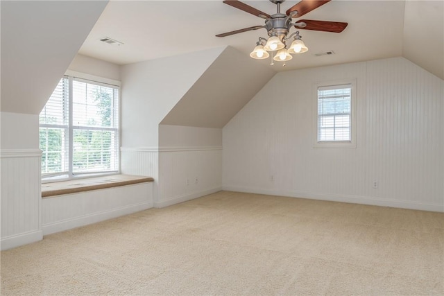 additional living space with ceiling fan, light carpet, and vaulted ceiling