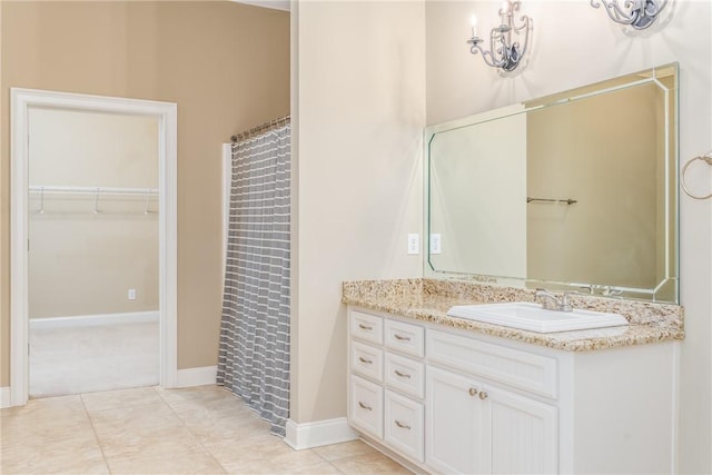 bathroom featuring vanity, tile patterned floors, and curtained shower