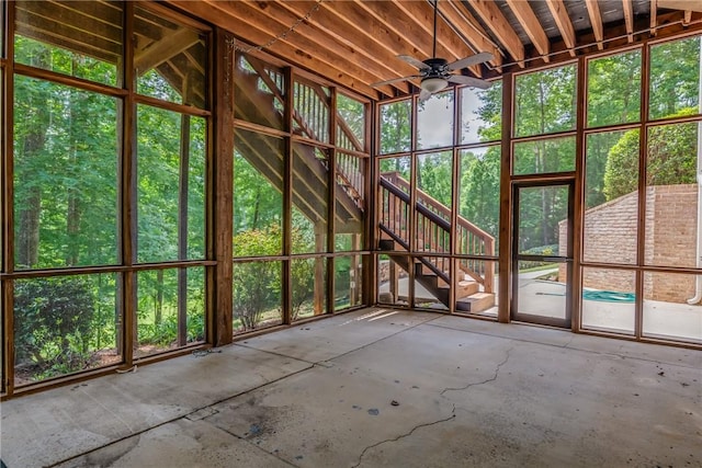 unfurnished sunroom with ceiling fan