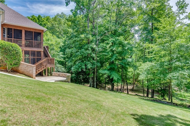 view of yard featuring a patio area and a sunroom