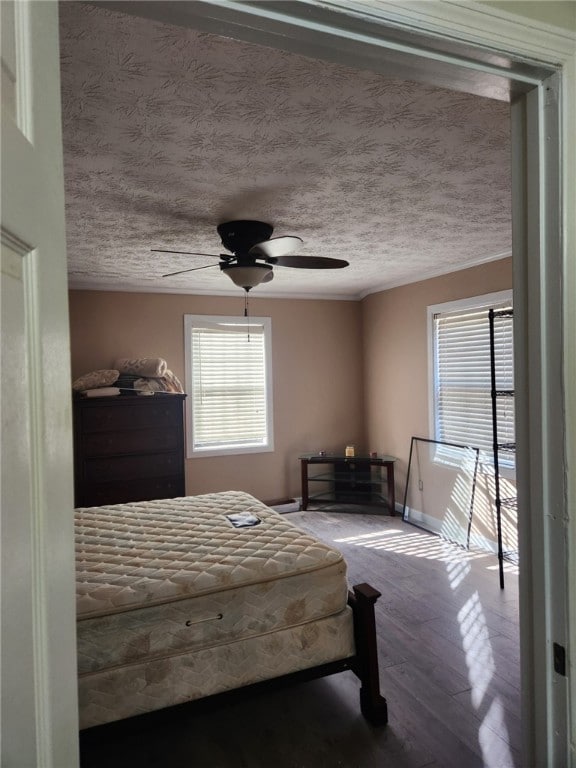 bedroom featuring hardwood / wood-style floors, a textured ceiling, and ceiling fan