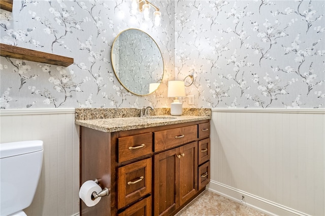 3515 Double Eagle Ln, Opelika, AL 36801 - bathroom featuring a wainscoted wall, wallpapered walls, vanity, toilet, and tile patterned floors