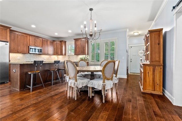 3515 Double Eagle Ln, Opelika, AL 36801 - dining space with a chandelier, ornamental molding, dark wood-type flooring, and baseboards