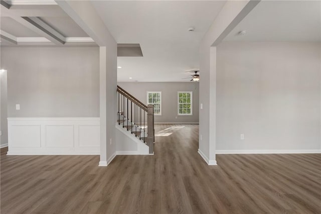 interior space with baseboards, ceiling fan, stairs, and wood finished floors