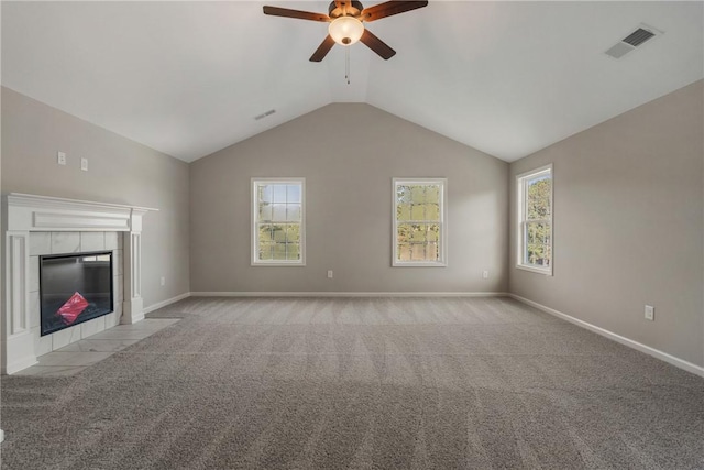 unfurnished living room featuring carpet flooring, a ceiling fan, visible vents, and vaulted ceiling