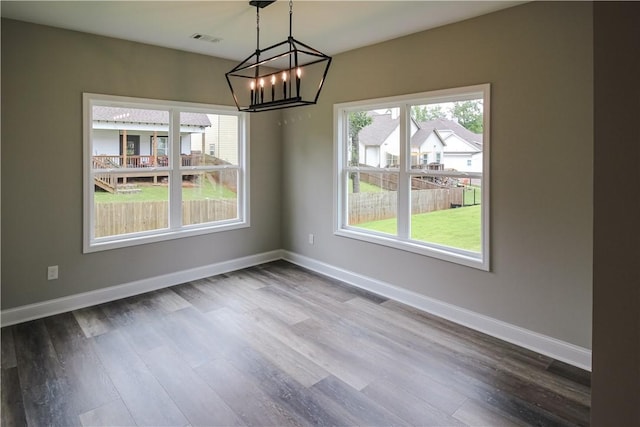 369 Lightness Dr, Auburn, AL 36832 - unfurnished dining area with a chandelier, dark wood-style flooring, and baseboards